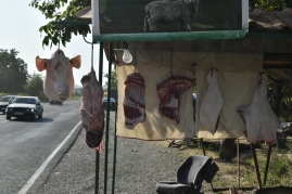 Cuts of pig hanging long the roadside