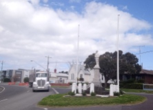 War memorial, white wood church, American truck ...the hat says "Australia".